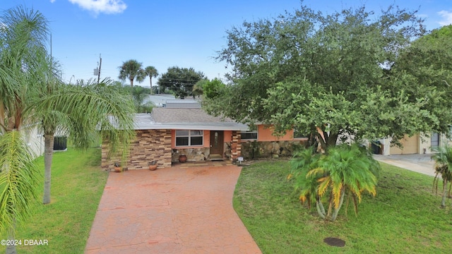 view of front of property with a garage and a front lawn