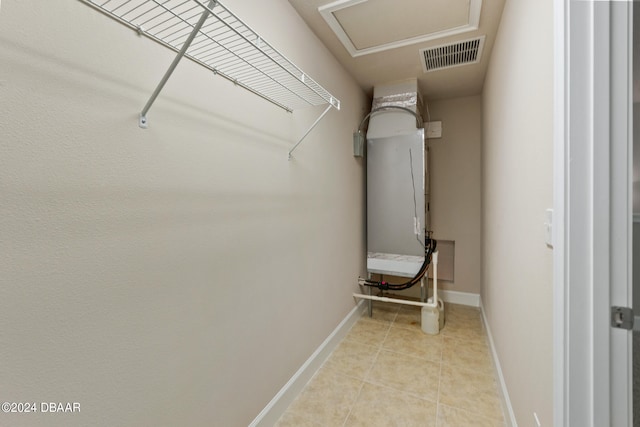 spacious closet with light tile patterned floors