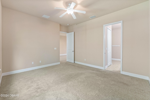 unfurnished room with ceiling fan and light colored carpet