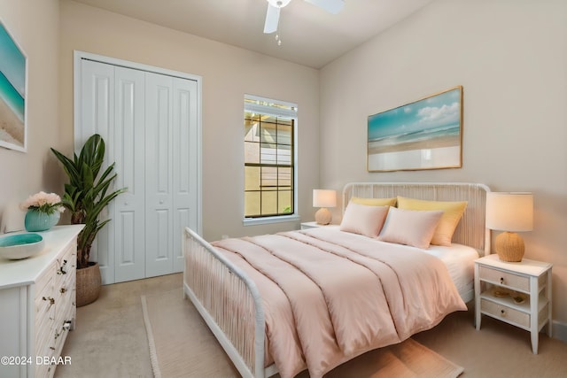 bedroom featuring ceiling fan, a closet, and light colored carpet