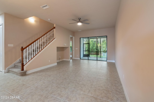 unfurnished living room featuring light tile patterned floors and ceiling fan