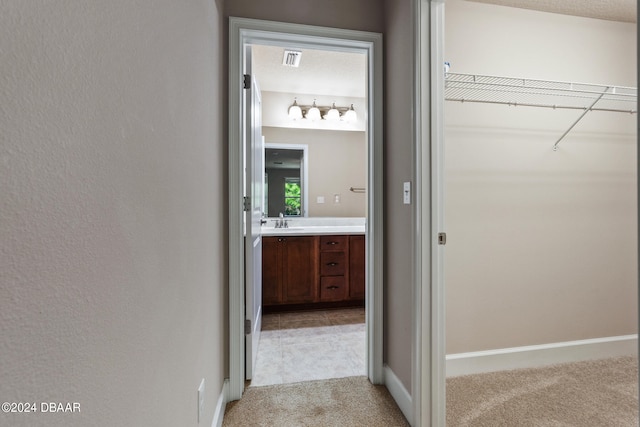 hall with light colored carpet