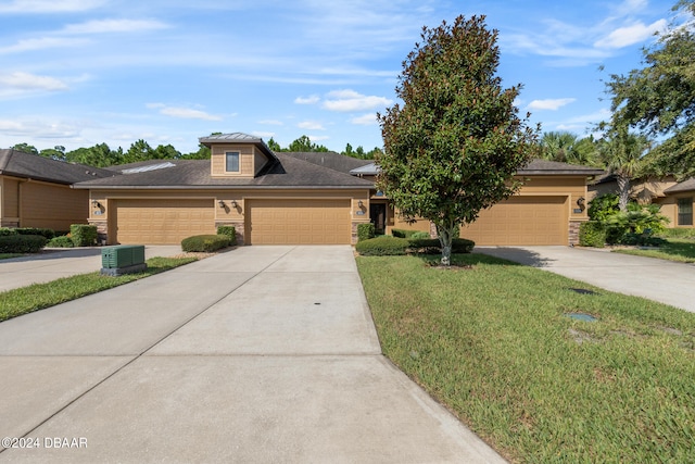 view of front of home featuring a garage and a front yard