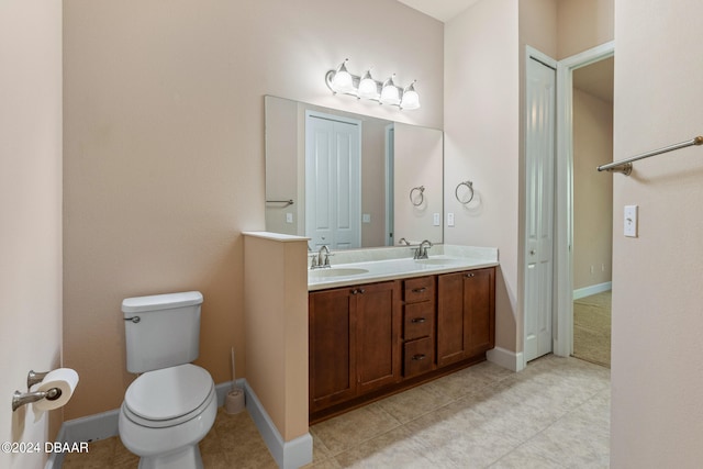 bathroom featuring toilet, vanity, and tile patterned flooring