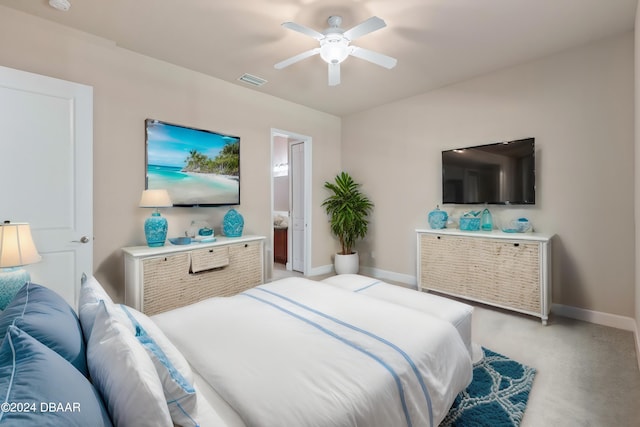 carpeted bedroom featuring ensuite bathroom and ceiling fan