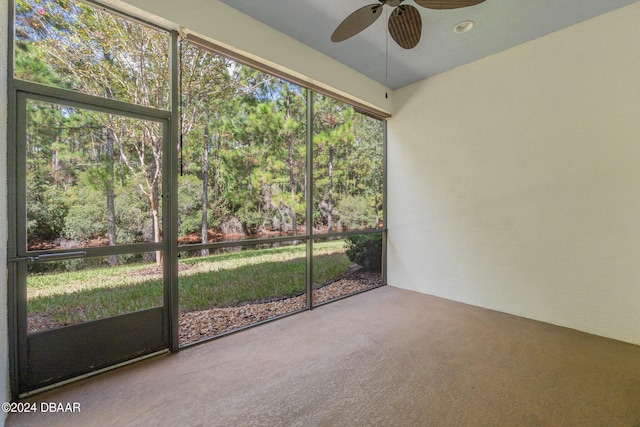 unfurnished sunroom featuring ceiling fan