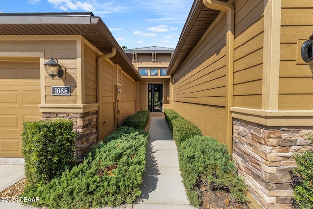 view of exterior entry featuring a garage