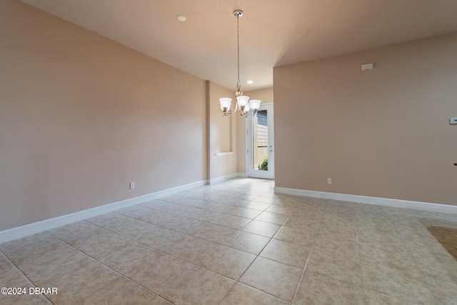 unfurnished room with light tile patterned floors and an inviting chandelier