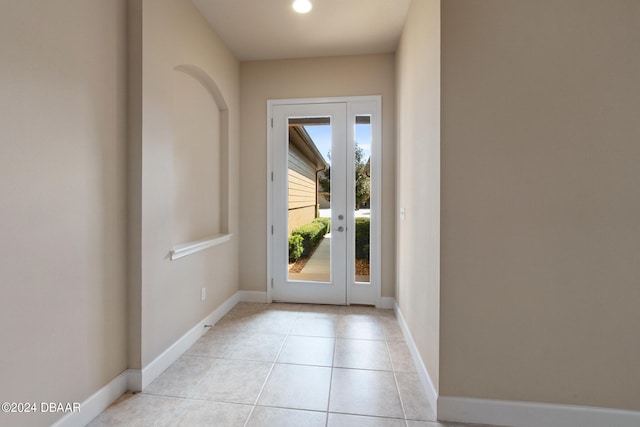 doorway with light tile patterned flooring