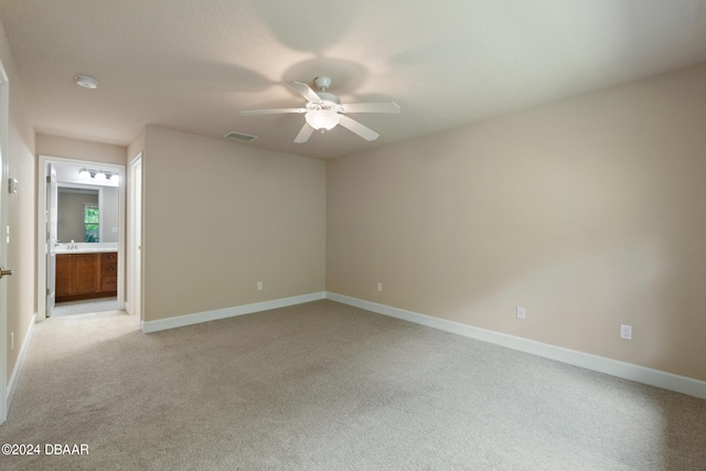 unfurnished room featuring light carpet and ceiling fan