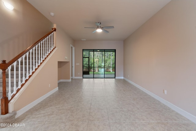 unfurnished living room with ceiling fan and light tile patterned floors