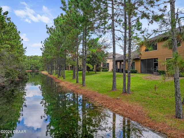 exterior space with a water view and a yard