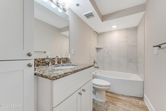 3797 S Atlantic Ave Unit 404, Daytona Beach, FL 32118 - full bath with toilet, vanity, wood finished floors, and shower / bathtub combination