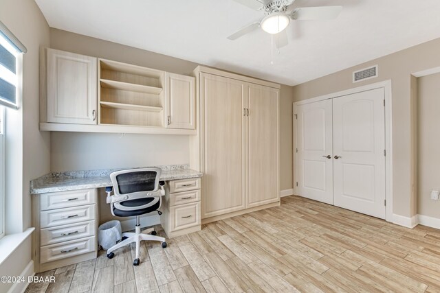 3797 S Atlantic Ave Unit 404, Daytona Beach, FL 32118 - unfurnished office with built in desk, light wood-style flooring, ceiling fan, and baseboards