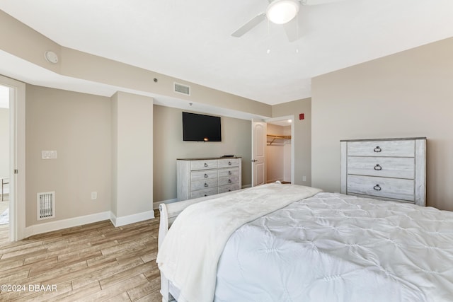 3797 S Atlantic Ave Unit 404, Daytona Beach, FL 32118 - bedroom with light wood-style floors, baseboards, a ceiling fan, and a spacious closet