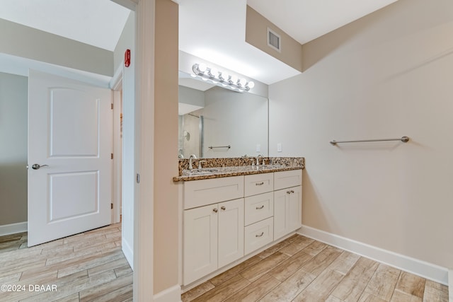 bathroom with vanity, a shower, and wood-type flooring