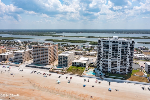 birds eye view of property featuring a beach view and a water view