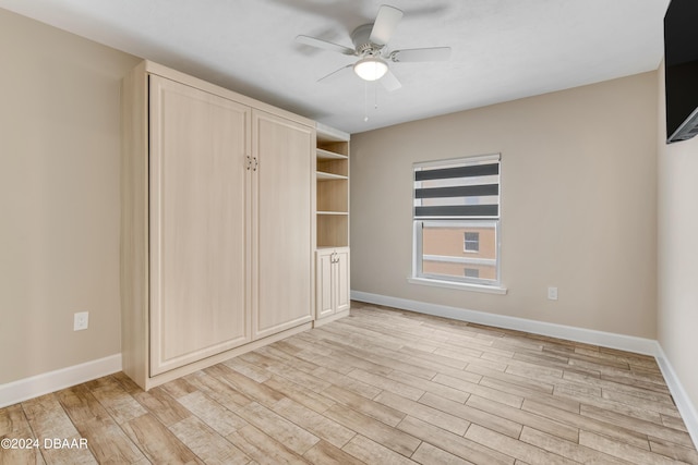 3797 S Atlantic Ave Unit 404, Daytona Beach, FL 32118 - unfurnished bedroom with light wood finished floors, baseboards, and ceiling fan