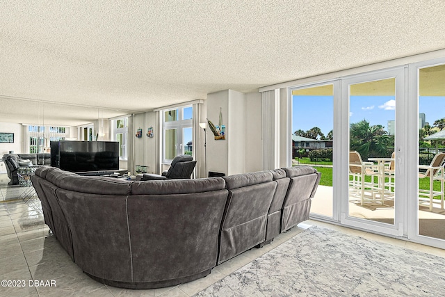 living room with a wall of windows, a wealth of natural light, and a textured ceiling