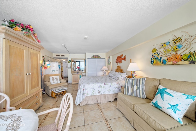 bedroom featuring a textured ceiling and light tile patterned floors