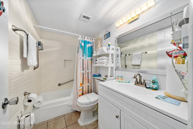 full bathroom featuring tile patterned flooring, shower / tub combo, a textured ceiling, vanity, and toilet