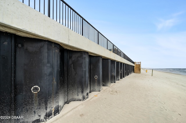 exterior space with concrete flooring and a beach view