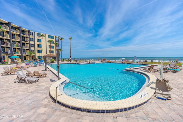 view of swimming pool with a water view