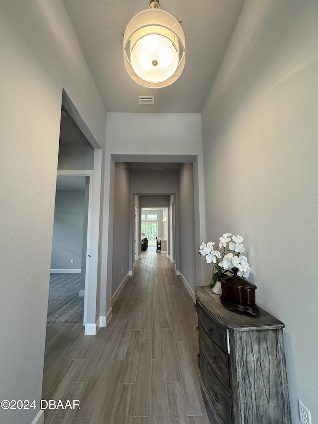 hallway with hardwood / wood-style flooring