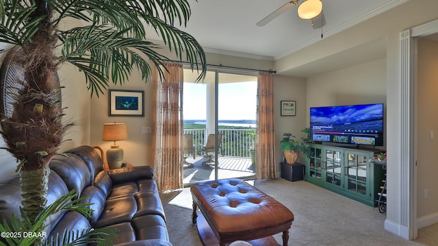 living room featuring ceiling fan, carpet, and crown molding