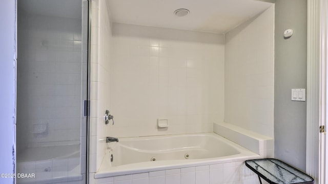 bathroom featuring shower with separate bathtub