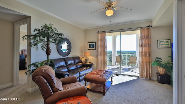 carpeted living room featuring ornamental molding and ceiling fan