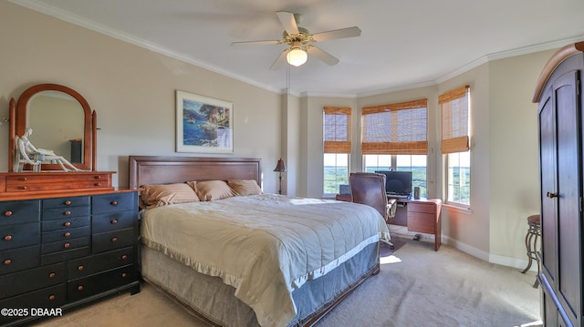 carpeted bedroom featuring ornamental molding and ceiling fan