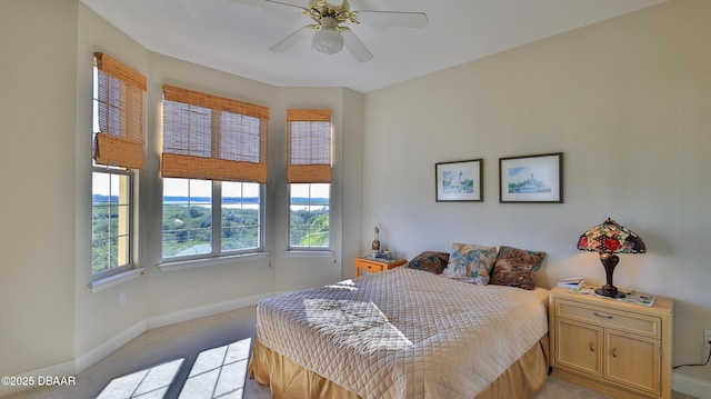 bedroom featuring ceiling fan and light carpet