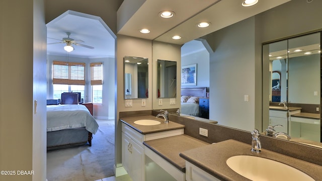 bathroom featuring ceiling fan, crown molding, and vanity