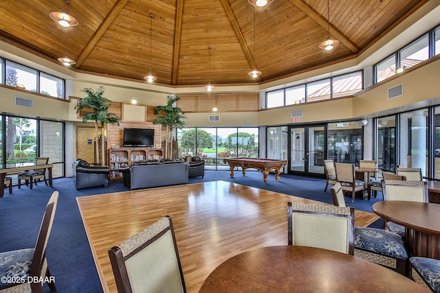 interior space with a high ceiling, beam ceiling, wooden ceiling, and pool table