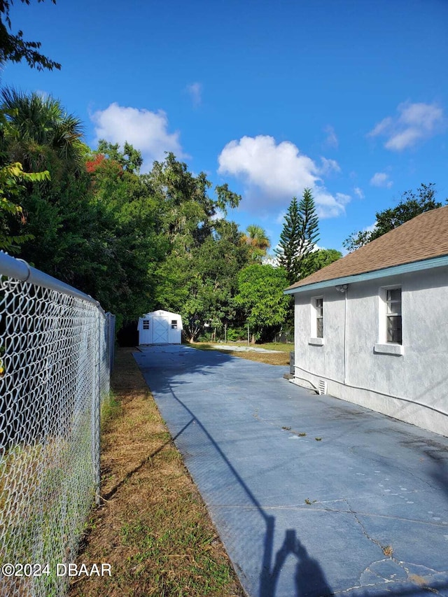 view of side of property with a shed