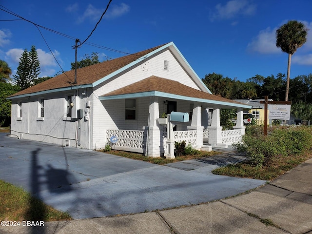 view of property exterior featuring covered porch