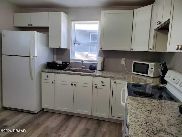 kitchen featuring white cabinets, white appliances, and sink