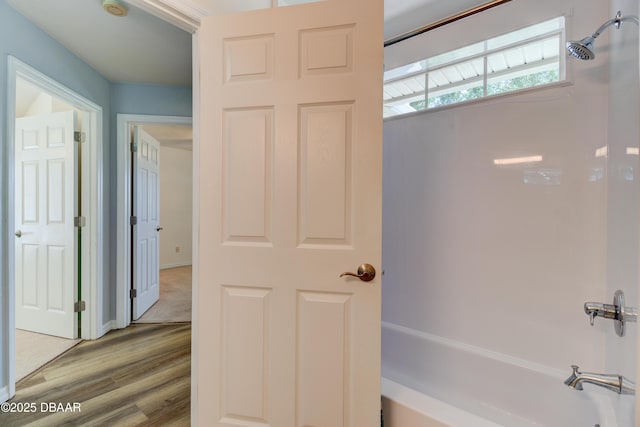 full bath featuring wood finished floors and shower / bathing tub combination