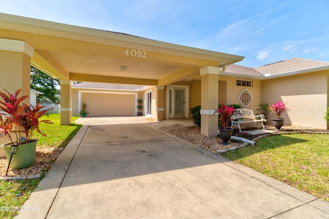 exterior space with concrete driveway, a front lawn, and stucco siding