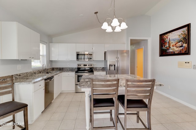 kitchen with white cabinetry, stainless steel appliances, a sink, and light tile patterned flooring