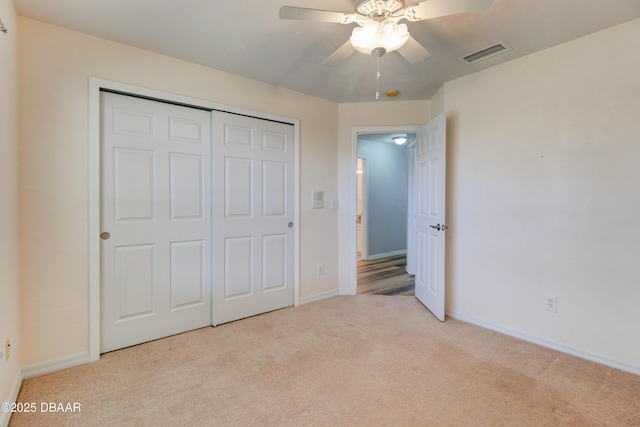 unfurnished bedroom featuring carpet, visible vents, and baseboards