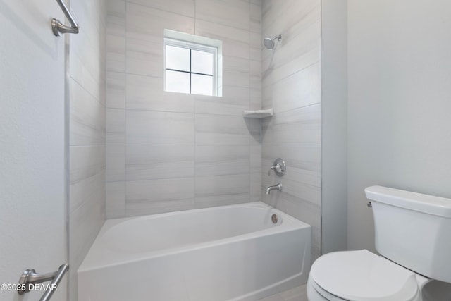 bathroom with toilet and tiled shower / bath