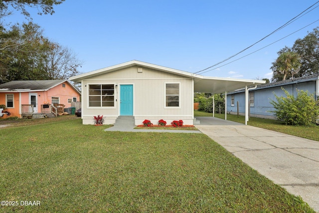 view of front of property with a front yard and a carport