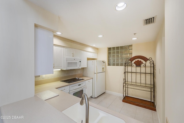 4624 Harbour Village Blvd Unit 4204, Ponce Inlet, FL 32127 - kitchen featuring recessed lighting, light countertops, visible vents, white appliances, and white cabinetry