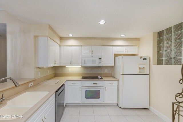 4624 Harbour Village Blvd Unit 4204, Ponce Inlet, FL 32127 - kitchen with white cabinets, a sink, white appliances, light countertops, and light tile patterned floors