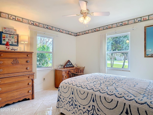 bedroom with multiple windows, baseboards, a ceiling fan, and light tile patterned flooring