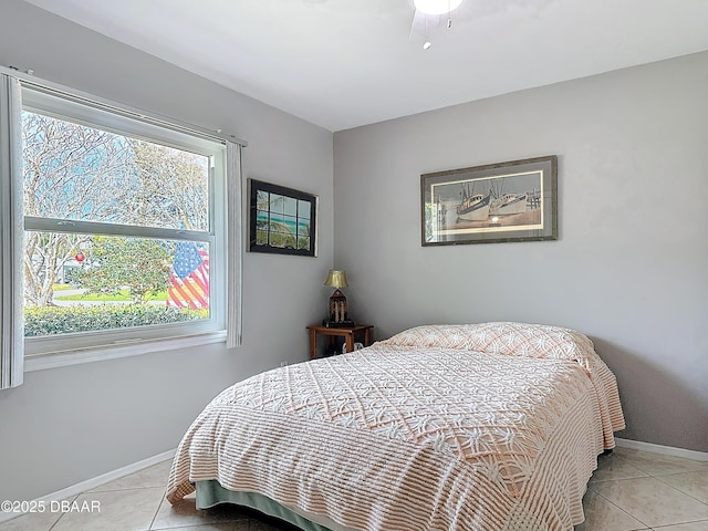 bedroom featuring light tile patterned floors and baseboards