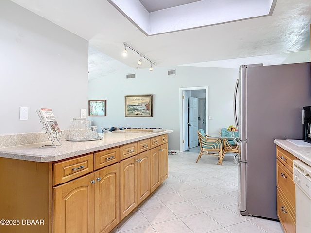 kitchen featuring visible vents, light countertops, dishwasher, and freestanding refrigerator