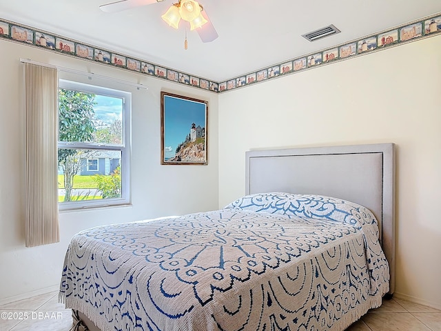 bedroom featuring tile patterned flooring, visible vents, and a ceiling fan